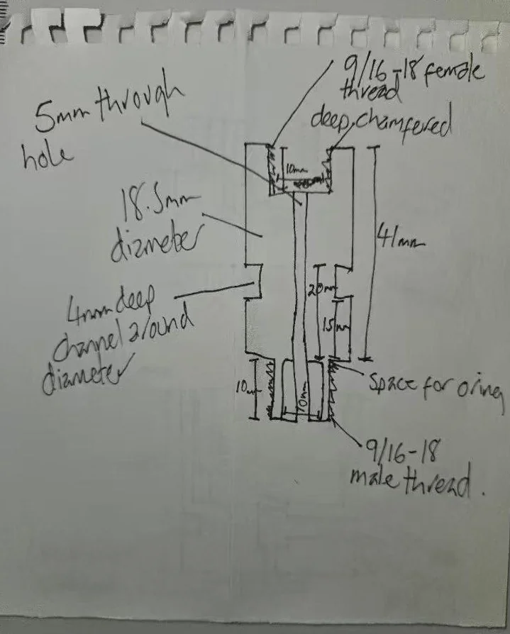 Customer hand sketch of a stainless steel coupler with 9/16-18 female thread on one end, 9/16-18 male thread on the other end, through-hole and O-ring chamfer
