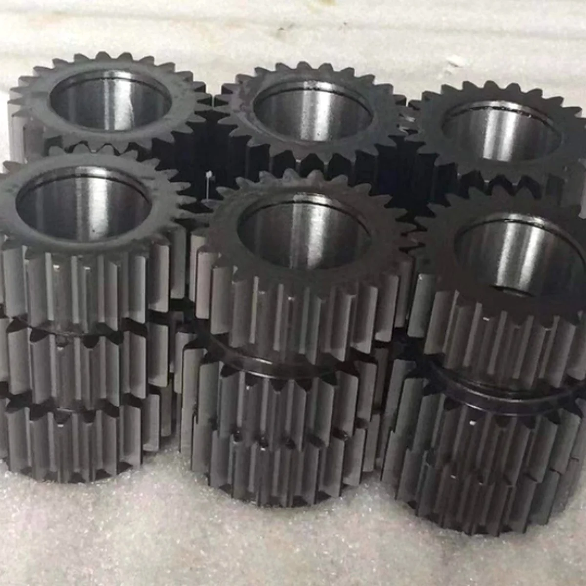 Batch of CNC-machined steel spur gears reproduced to match an original by EKINSUN, identical tooth profile and bore