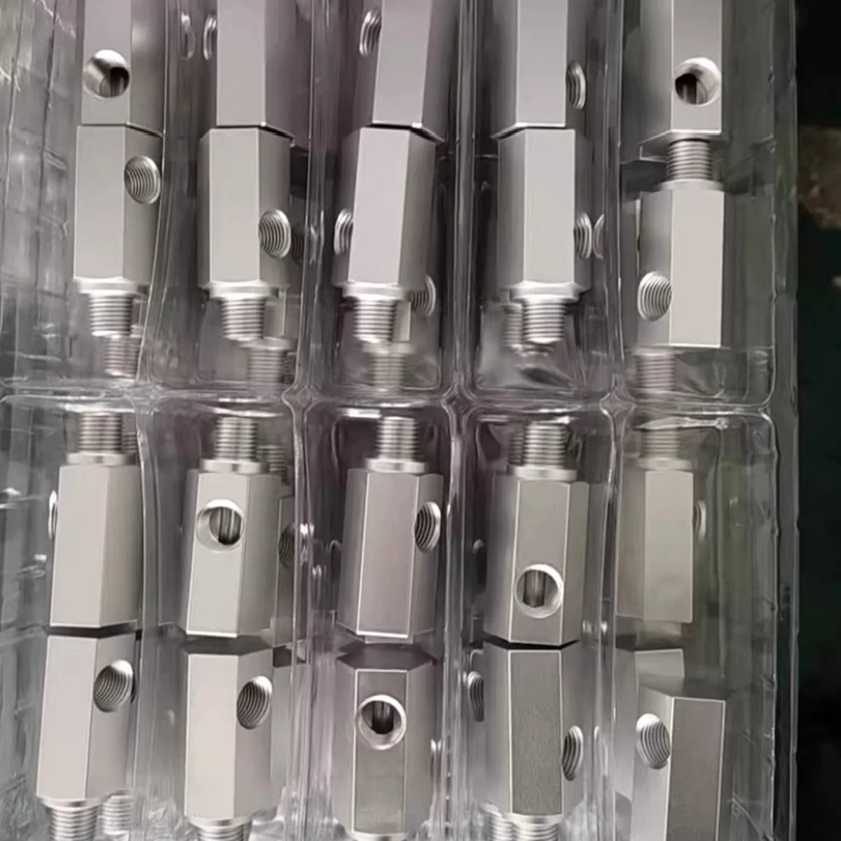 CNC machined stainless valve bodies packed in blister trays ready for export — EKINSUN