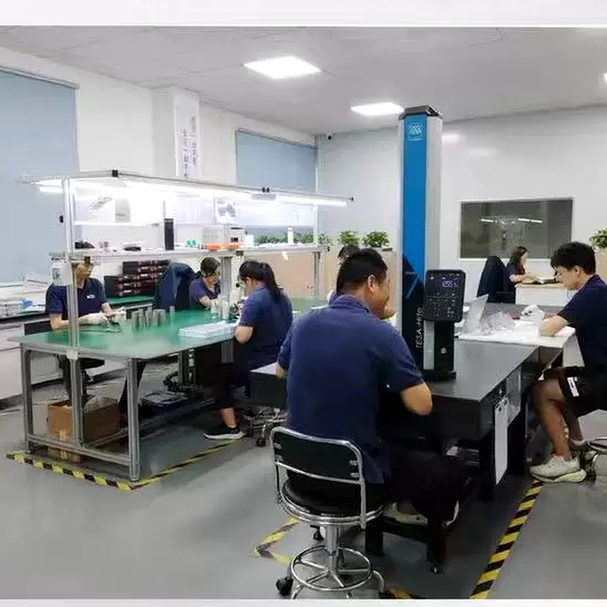 EKINSUN QC inspection room with TESA CMM machine — engineers inspecting precision parts Guangdong